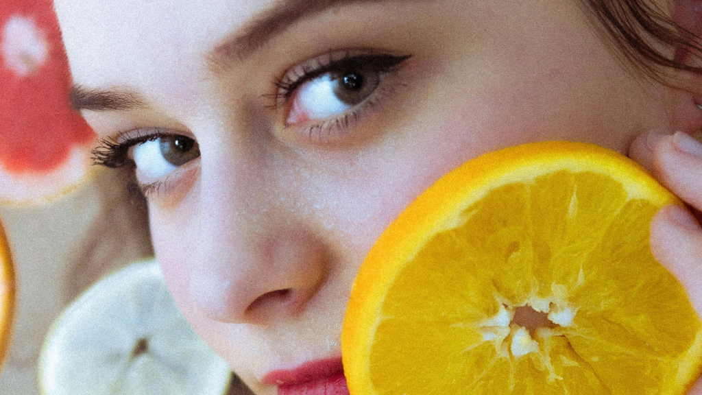 Beautiful Woman with Orange Slices on Face